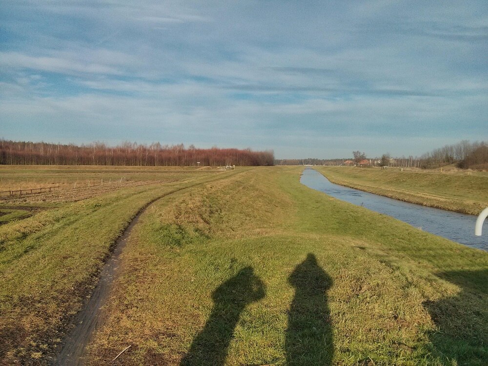 große Wiese, rechts davon ein Fluss und wieder Wiese daneben